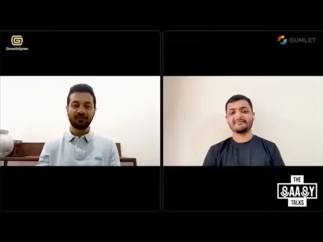 Two men in virtual meeting panels, man on left in white shirt, man on right in black shirt.